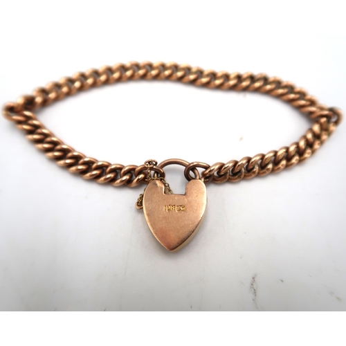 212 - A hallmarked 9ct yellow gold curb link bracelet with heart shaped padlock clasp - approx weight 20.5... 