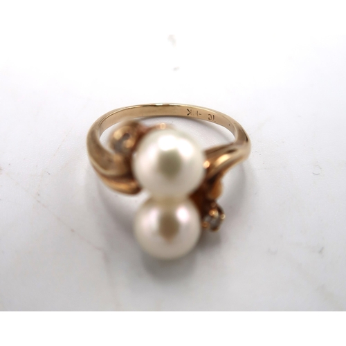 234 - A 10ct gold, marked, white stone and pearl ring set with two pearls, size K, 3.1g.