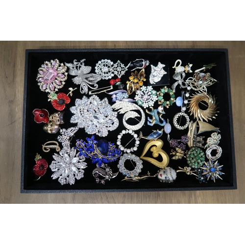 247 - A large group of vintage and later costume jewellery, predominantly brooches, including jet, vintage... 