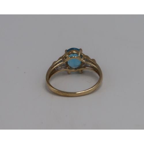 25 - A 9ct gold dress ring with oval cut topaz flanked by six small round cut clear stones, marked 375, s... 