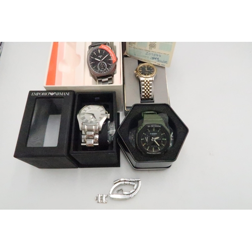 269 - An Emporio Armani stainless steel gents wristwatch and a Fossil Hybrid smartwatch, a G Shock gents w... 