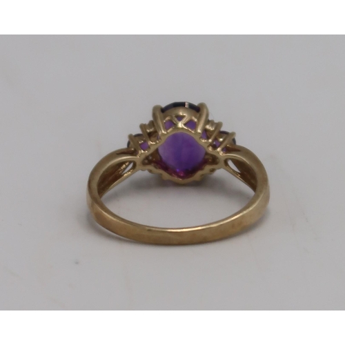 27 - A 9ct gold and amethyst dress ring, set with oval and round cut amethysts, size S, marked .375, appr... 