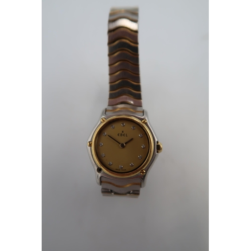 277 - An Ebel wristwatch, the signed champagne dial with Roman numerals, in two tone slim case, numbered 5... 