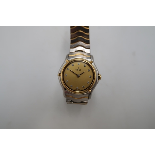 277 - An Ebel wristwatch, the signed champagne dial with Roman numerals, in two tone slim case, numbered 5... 