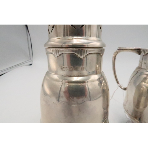 348 - An Art Deco silver cream jug, of tall proportions with curvilinear border to the rim and thumb-piece... 