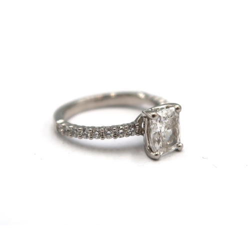 4 - A 1ct radiant cut diamond engagement ring the central stone flanked by 16 small round cut diamonds -... 