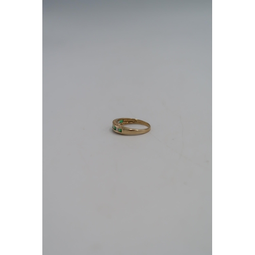 45 - A 14ct gold dress ring set with green and clear paste, size T, marked 585, 3.0g.