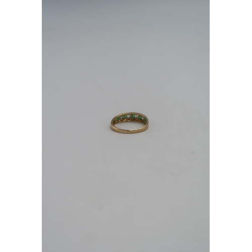 45 - A 14ct gold dress ring set with green and clear paste, size T, marked 585, 3.0g.