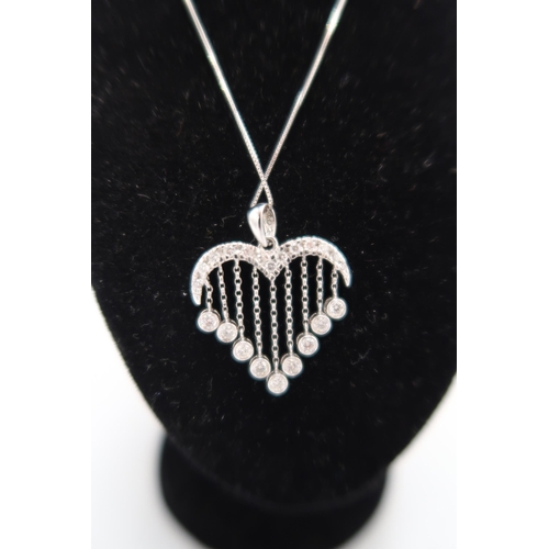 58A - A diamond heart pendant. Designed as a curved diamond surmount, suspending a graduated articulated d... 