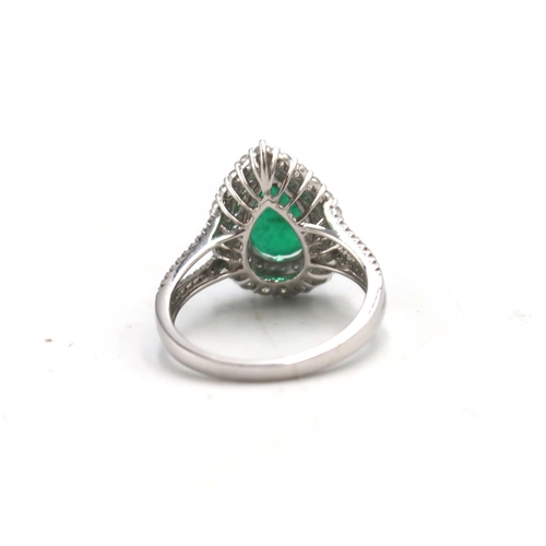 6 - An 18ct white gold dress ring with pear cut emerald to shoulder, 1.96ct, surrounded by 0.64ct of dia... 