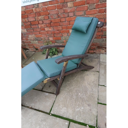 626 - A teak steamer chair with cushions.