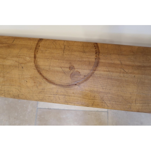 627 - An oak bench from the Leys School dining hall, 280cm long by 47cm high.