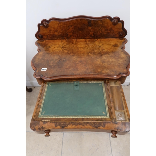 669 - A Victorian burr walnut, two tier side table, with frieze drawer having adjustable tooled leather wr... 