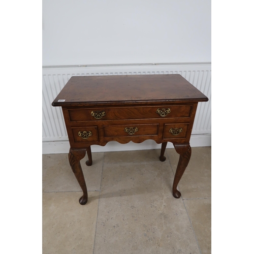 671 - A 20th century figured walnut four drawer lowboy, 75.5 by 45.5 by 78cm high.