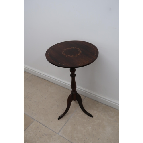 673 - A rosewood and satinwood inlaid wine table on a turned tripod base, 43.5cm diameter by 76cm high.