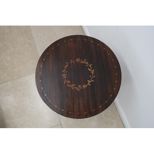 673 - A rosewood and satinwood inlaid wine table on a turned tripod base, 43.5cm diameter by 76cm high.