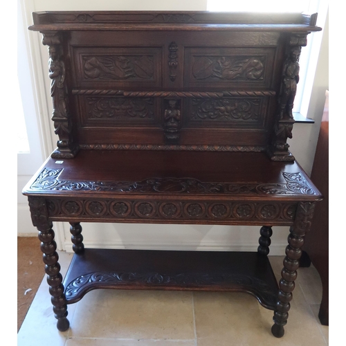 678 - A carved side table, a 1930's heavily carved oak side cabinet, 115cm wide x 140cm tall