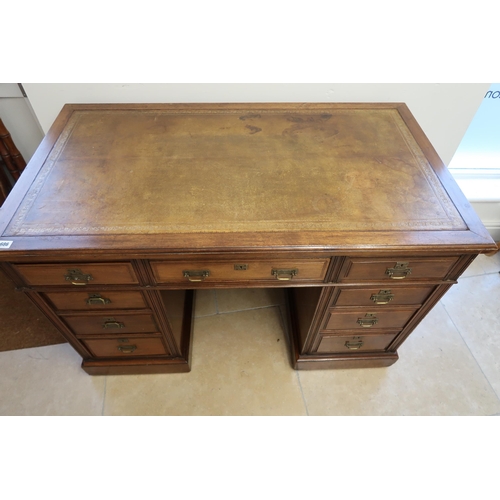 686 - A Maple & Co twin pedestal desk, tooled leather top over long drawer flanked by small drawers raised... 