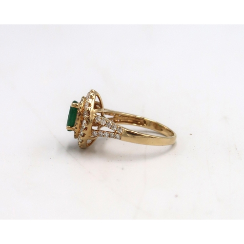 7 - An 18ct Yellow Gold dress ring with oval cut Emerald 1.5ct, surrounded by a double halo of Diamonds ... 