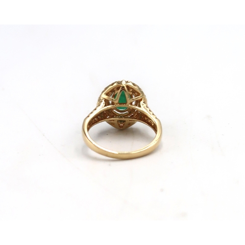 7 - An 18ct Yellow Gold dress ring with oval cut Emerald 1.5ct, surrounded by a double halo of Diamonds ... 