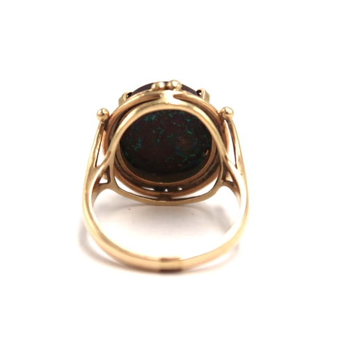 81 - A 9ct H.M. yellow gold and black opal dress ring 5.2grams, Size P.