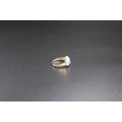 90 - A 9ct gold foliate engraved wedding band, size U, and a 9ct gold, diamond and topaz three stone ring... 