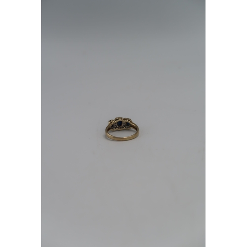 92 - A 9ct gold dress ring set with three oval cut sapphires, each surrounded by a halo of diamond brilli... 