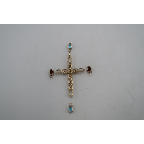 97 - A 9ct gold cross pendant, marked .375 of open oval weave design and set with seven green sapphires, ... 