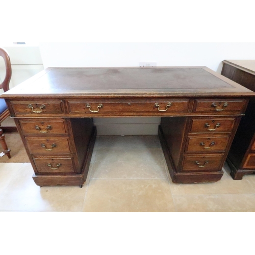 702 - A late Victorian oak nine drawer twin pedestal desk, tooled leather top, 135cm wide x 67cm deep x 73... 