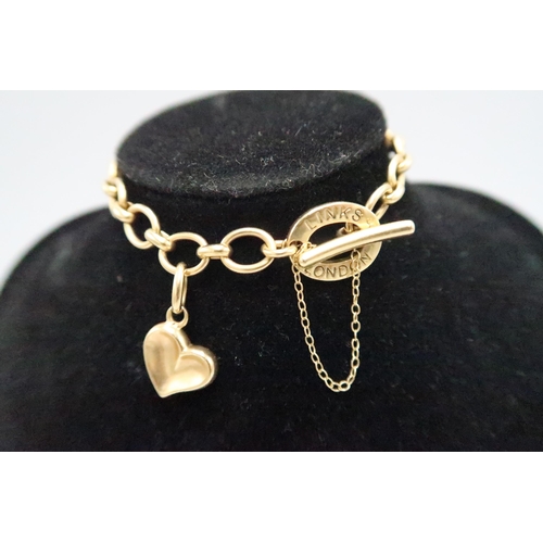 1 - LINKS OF LONDON - An 18ct gold ladies charm bracelet with heart charm - approx length 19cm - approx ... 