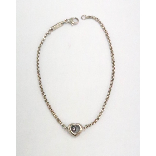 59 - A Chopard 18ct white gold floating diamond heart bracelet, with heart shaped pendant on chain - Leng... 