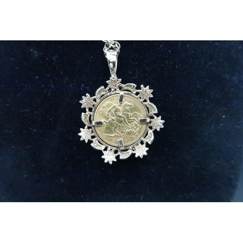 373 - A Victoria veiled head half sovereign, 1897, in 9ct gold floral pendant mount with 9ct gold chain, t... 