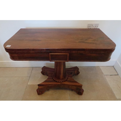 638 - A 19th century rosewood fold over card table