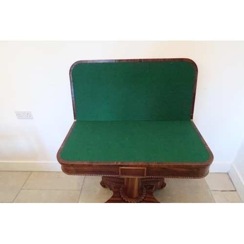 638 - A 19th century rosewood fold over card table