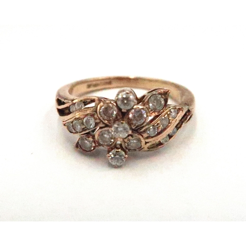 64 - A 9ct gold and white stone dress ring of swirling leaf design, size M, 2.9g.