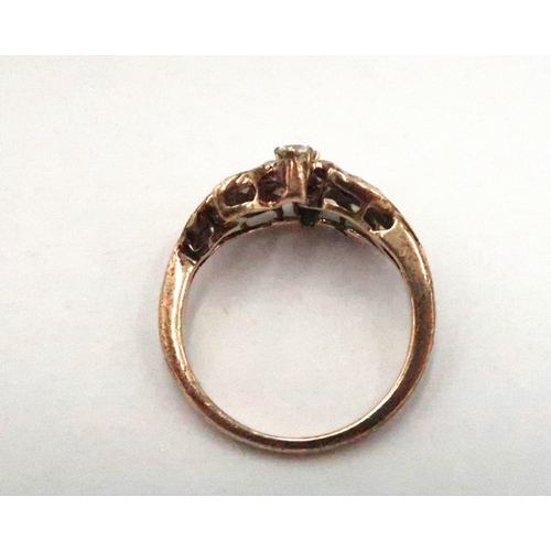 64 - A 9ct gold and white stone dress ring of swirling leaf design, size M, 2.9g.