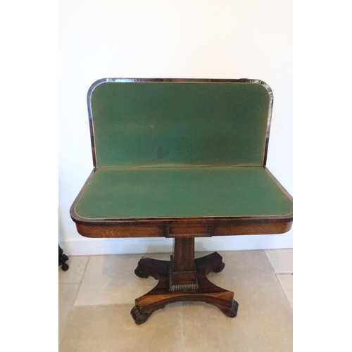 641 - A 19th century rosewood veneered card table, folding swivel top over single column support terminati... 