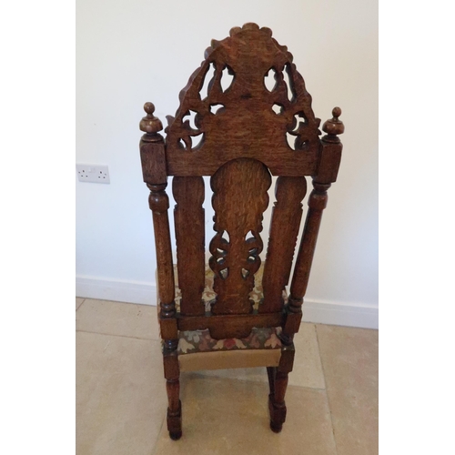 643 - A carved oak Carolean style hall chair, profusely carved with overstuffed seat raised on turned and ... 