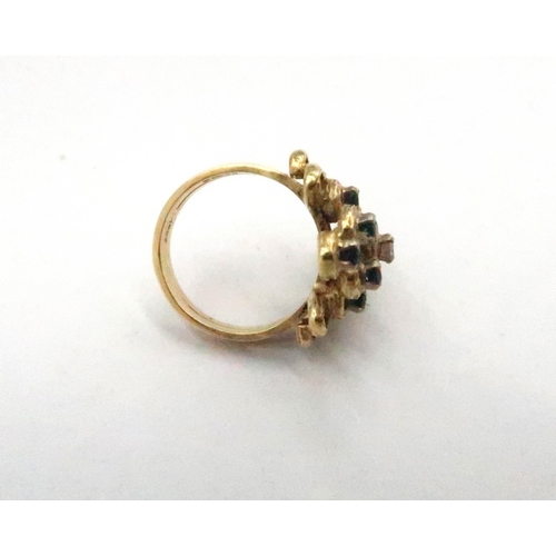 70 - A 15ct marked yellow gold dress ring with two central diamonds approx 0.1ct each flanked by eight sa... 