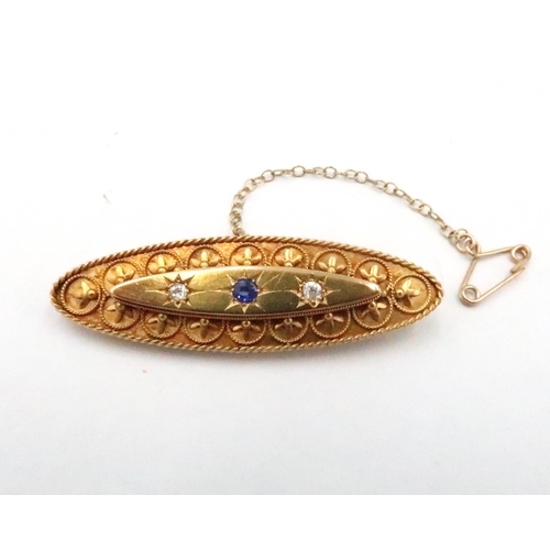 74 - A 15ct gold sapphire and old cut diamond oval bar brooch with filigree detail. Length 49mm. Weight 5... 