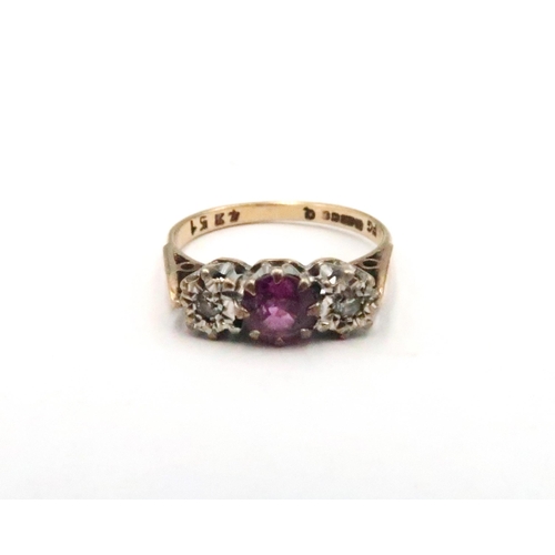 82 - A 9ct gold pink sapphire and diamond three stone ring. Size M 1/2. Weight 2.33 grams