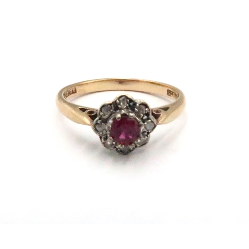 84 - A 9ct gold ruby and diamond cluster ring. Size L 1/2. Weight 2.02 grams