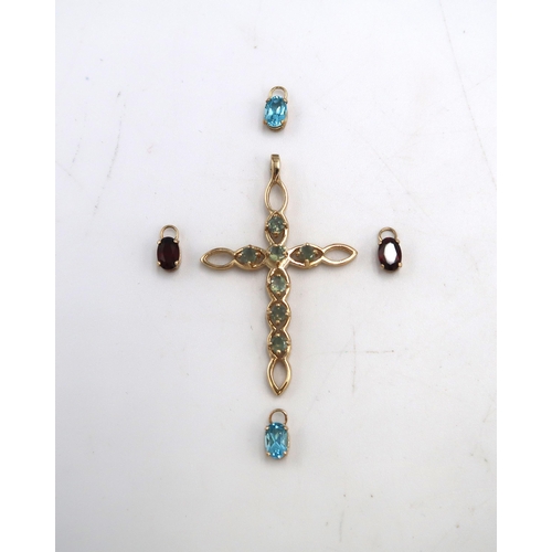 99 - A 9ct gold cross pendant, marked .375 of open oval weave design and set with seven green sapphires, ... 