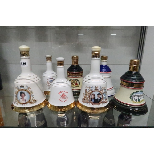 527 - A group of seven Bells Whisky decanters, all full, including Christmas 1988 and 1989.