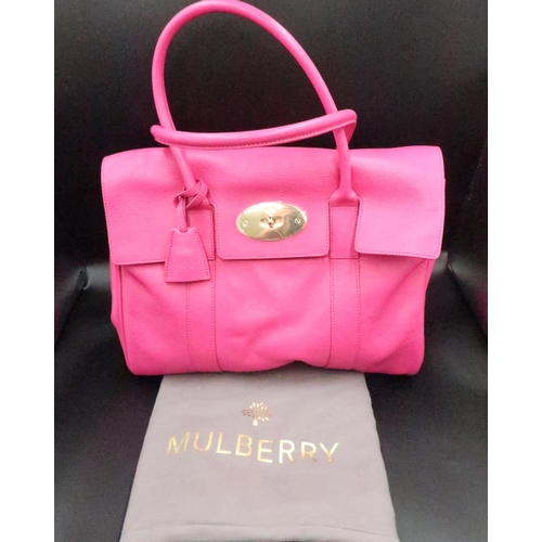 450 - A Mulberry Bayswater handbag, Fuscia pink with gold  coloured hardware - in brand new condition with... 