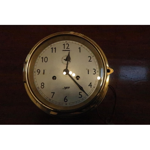 613 - A ship's clock, brass cased, dog watch strike, Arabic numerals, circa 1980.