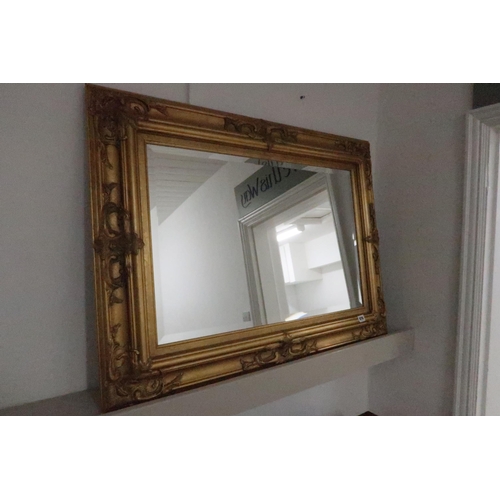 678 - A bevelled edge mirror with gold effect frame - 76cm x 104cm