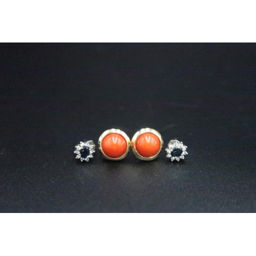 127 - A pair of gold and coral earrings, stems indistinctly marked but possibly 18ct, with 18ct gold butte... 