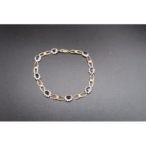 138 - A 9ct gold sapphire and diamond cluster panel bracelet. Weight 5.59 grams