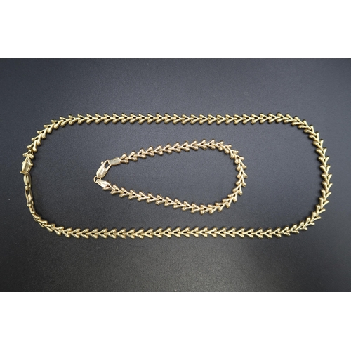 142 - A 9ct gold fancy link necklace and bracelet set. Weight 16.52 grams